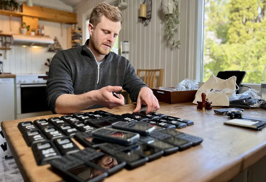 Arne putting phone batteries in the dumbphones